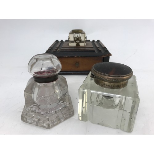 125 - 2 HEAVY CUT GLASS VICTORIAN INK WELLS TOGETHER WITH ONE OTHER ON A WOODEN BASE WITH DRAWER