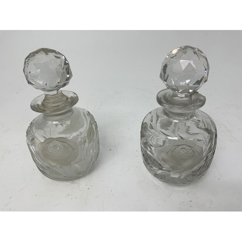 101 - PAIR OF GOOD QUALITY CUT GLASS DRESSING TABLE BOTTLES WITH ROSE DECORATION