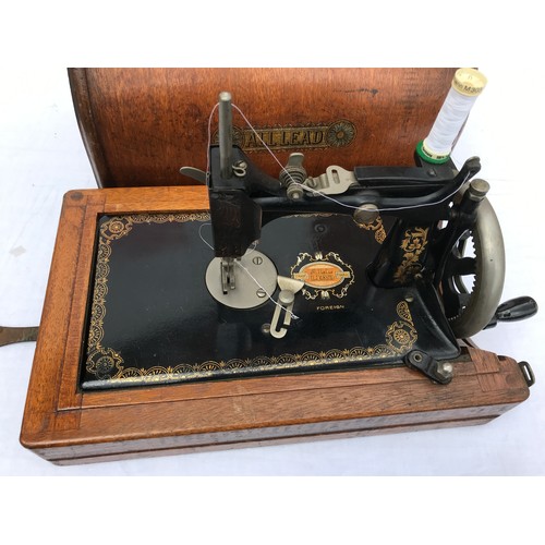 508 - A CASED ALLLEAD SEWING MACHINE