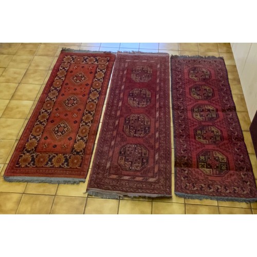 258 - 3 RED GROUND RUG RUNNERS, LARGEST 157CM. X 55CM.