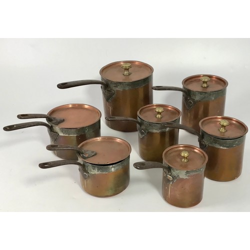 435 - GRADUATED ANTIQUE COPPER SAUCEPANS AND COVERS (7)