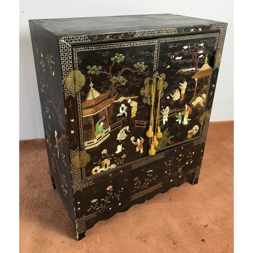 327 - ORIENTAL EBONINSED LACQUER CABINET 2 DOORS DECORATED WITH RELIEF WITH COLOUR STONES AND BONER FIGURE... 