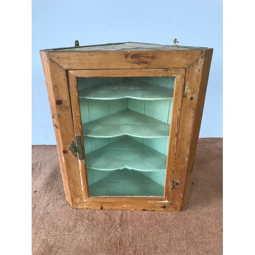 133 - STRIPPED PINE HANGING CORNER CABINET