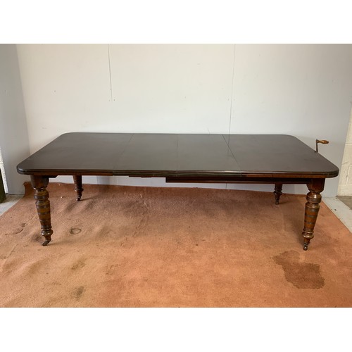 240 - EXTENDING VICTORIAN MAHOGANY DINING TABLE WITH 2 LEAVES, A WINDING HANDLE AND TURNED LEGS. APPROX 23... 