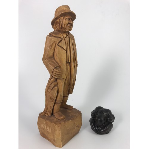 505 - TWO TREEN ITEMS; A V FORTIN HAND CARVED FISHERMAN AND AN EBONY CARVING OF A SUMO WRESTLER