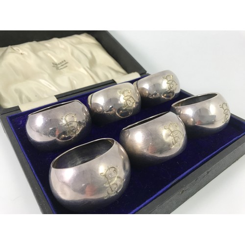 314 - CASED SET OF 6 SILVER SERVIETTE RINGS IN FITTED POPHAMS BOX