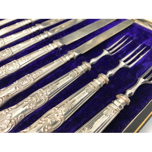 305 - SILVER HANDLED CASED DESSERT KNIVES AND FORKS AND CRUET SET ON PLATED STAND AND A SILVER HANDLED CAS... 