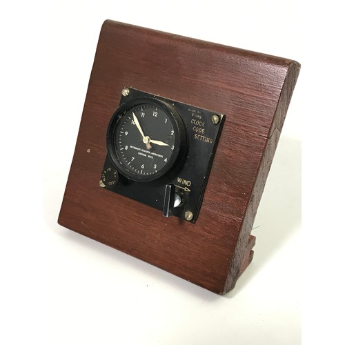 65 - MILITARY CLOCK IN WOODEN DISPLAY STAND INSTRUMENT RESEARCH LABORATORY, COSHAM, WILTSHIRE