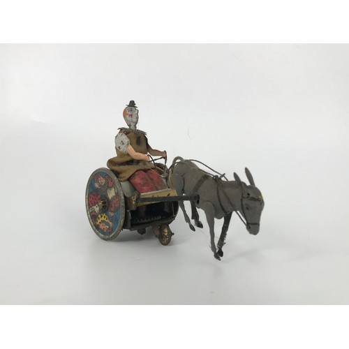 84 - TOY CLOWN DRIVING A DONKEY, MADE BY BILD GESCH OF GERMANY.