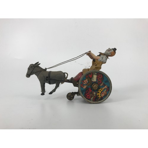 84 - TOY CLOWN DRIVING A DONKEY, MADE BY BILD GESCH OF GERMANY.