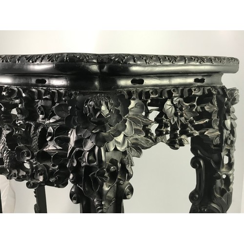 282 - HEAVILY CARVED ORIENTAL HARD WOOD CONSOLE TABLE OF SERPENTINE FORM HAVING INSET MARBLE TOP