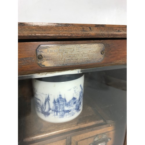 557 - OAK SMOKERS CABINET, SILVER PRESENTATION PLATE INSCRIBED C. 1922