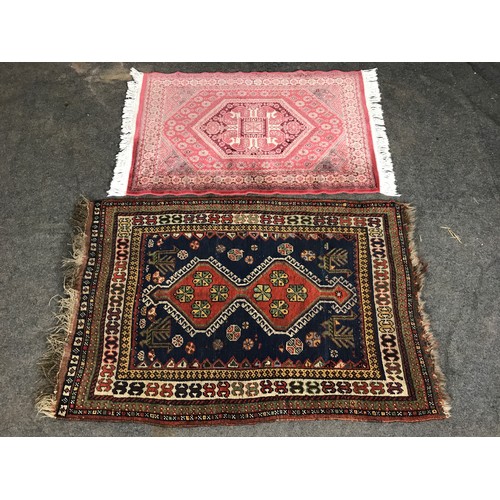 414 - 2 GROUND RUGS, ONE COLOURFUL WITH MAINLY BLUE AND RED CENTRE DESIGN, ANOTHER PINK SILK RUG. LARGEST ... 