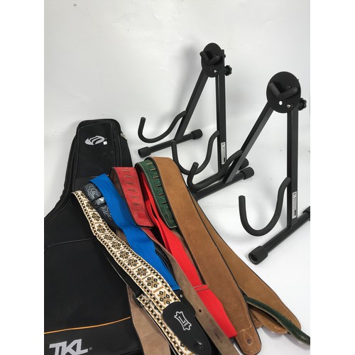 472 - 2 GUITAR STANDS A009D, A SOFT CASE, AND A COLLECTION OF 7GUITAR STRAPS BY TGI LEVY'S.