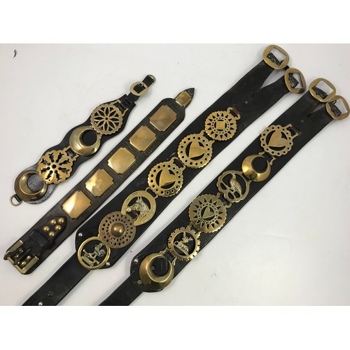 497 - COLLECTION OF HORSE BRASSES ON LEATHER STRAPS