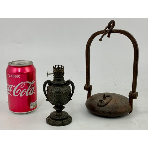 345 - CAST IRON HANGING LAMP AND AN ORNATE MINIATURE OIL LAMP