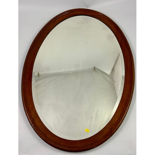 61 - LARGE OVAL MAHOGANY FRAMED BEVELLED MIRROR, APPROX. 84 X 59 cm