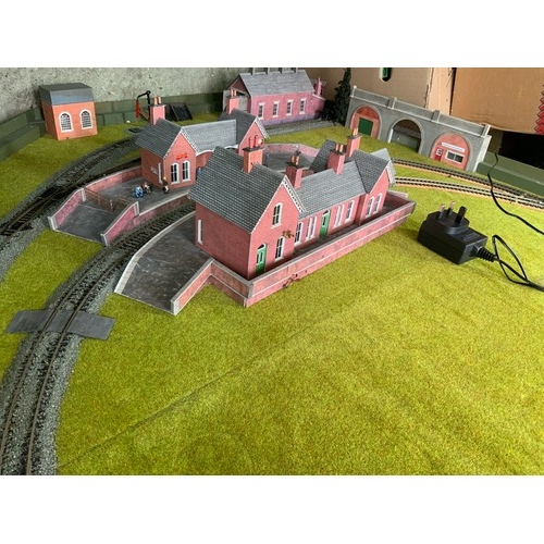 425 - MODEL RAILWAY LAYOUT, ON SOLID CHIPBOARD BASE WITH CIRCLE, OUTER LOOP, ENGINE SHED & GOODS SHED. MET... 