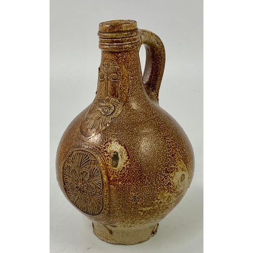 83 - BELLARMINE JUG, A SMALL 17TH CENTURY GERMAN SALT GLAZED FLAGON FEATURING A BEARDED MASK ABOVE A SEAL... 