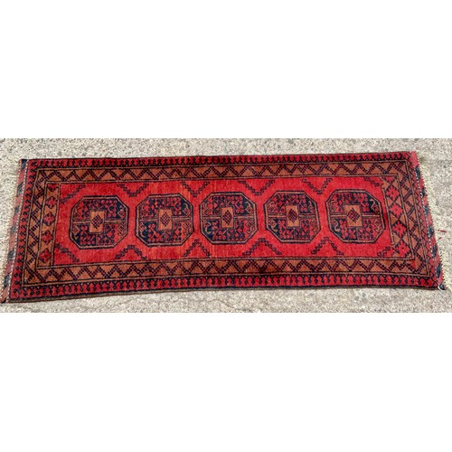 673 - AFGHAN RED GROUND RUNNER, APPROX. 180 X 63 cm