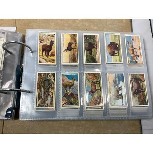 223 - A RING BINDER CONTAINING CIGARETTE CARDS FROM A RANGE OF MANUFACTURERS ALSO SOME BROOK BOND TRADE CA... 