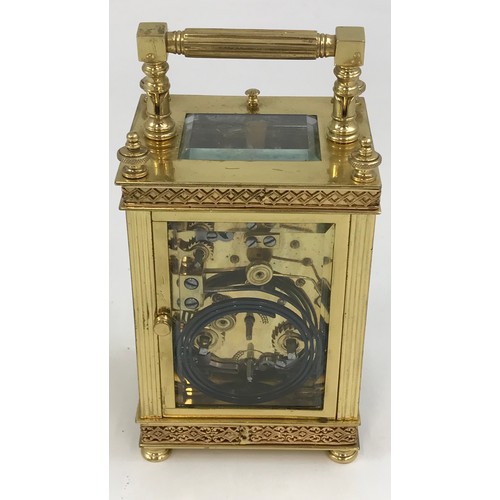 187 - AN ORNATE BRASS AND GILT BRASS REPEATING CARRIAGE CLOCK, WHITE ENAMEL DIAL WITH SUBSIDIARY SECONDS D... 