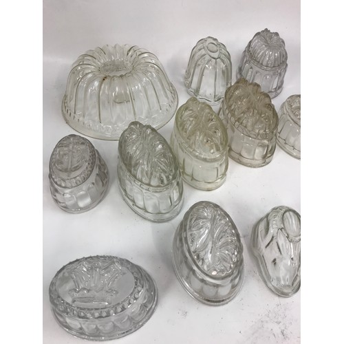 182 - COLLECTION OF GLASS JELLY MOULDS, INCLUDING A SET OF THREE GRADUATED RABBIT FORM MOULDS, ETC