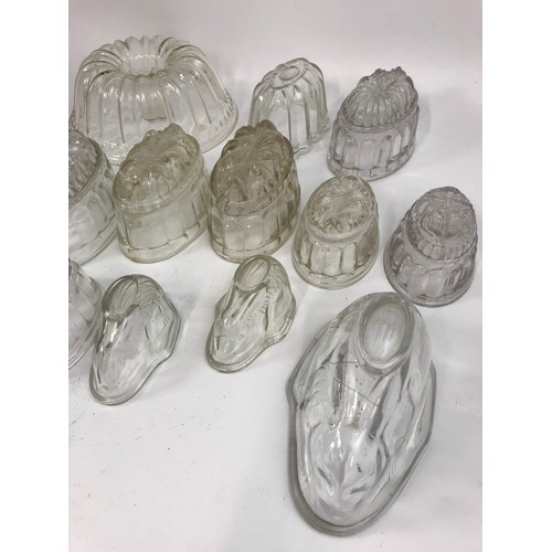 182 - COLLECTION OF GLASS JELLY MOULDS, INCLUDING A SET OF THREE GRADUATED RABBIT FORM MOULDS, ETC