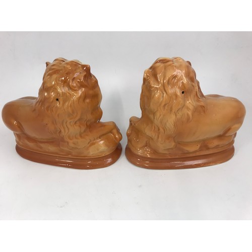 318 - A PAIR OF LATE 19TH CENTURY STAFFORDSHIRE STYLE LIONS, EACH ON OVAL PLINTH BASE