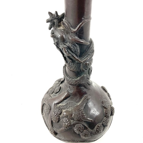 459 - A MEIJI PERIOD BRONZE VASE, GLOBE AND SHAFT FORM, MODELLED IN RELIEF WITH A WRYTHEN DRAGON, AMID PRU... 