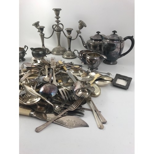 321 - A LARGE COLLECTION OF SILVER PLATED WARE INC. WALKER & HALL TEA SET, CANDLESTICKES CUTLERY  ETC.