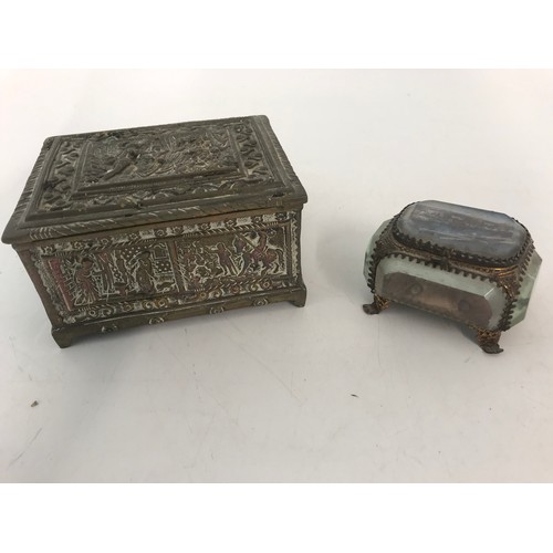 263 - GLASS DISPLAY BOX , ENAMEL BOX , BRASS EMBOSSED TRINKET BOX & TWO WHITE METAL BOXES