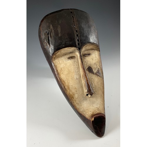 246 - AN AFRICAN GABON REGION  ‘FANG’  CARVED WOOD CEREMONIAL MASK,  WITH ELONGATED FEATURES AND APPLIED K... 