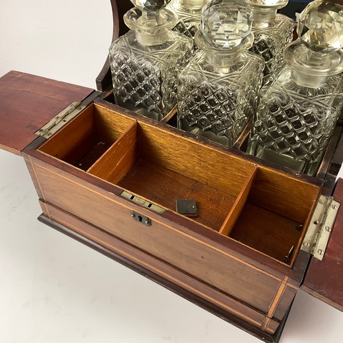 251 - AN EDWARDIAN MAHOGANY AMD BOXWOOD STRUNG THREE BOTTLE TANTALUS WITH LIDDED COMPARTMENTED GLASS HOLDE... 