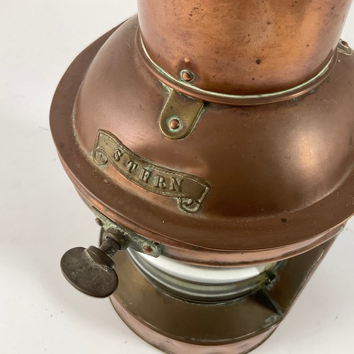 222 - A COPPER AND BRASS MOUNTED STERN LIGHT WITH BRASS SWING HANDLE, 27CM HIGH, TOGETHER WITH A BRASS CAS... 