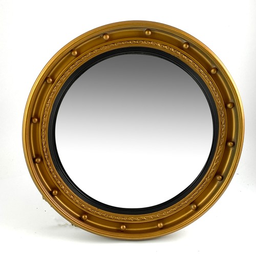 64 - A REGENCY STYLE CIRCULAR CONVEX GILT FRAMED WALL MIRROR WITH APPLIED BALL DECORATION, 53CM DIAMETER