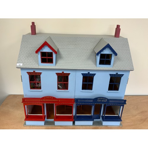 36 - A DOUBLE FRONTED DOLLS HOUSE WITH SHOP FRONTS, APPROX 82 CM WIDE, WITH A SELECTION OF DOLLS HOUSE FU... 