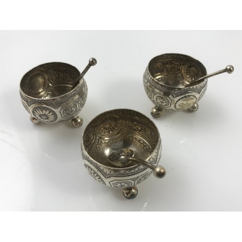 386 - INDIAN WHITE METAL DISH AND THREE SILVER SALTS WITH SPOONS