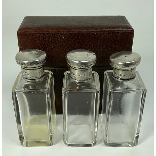 292 - ASPREY & CO. LEATHER CASE WITH 3 MATCHED BOTTLES EACH WITH A HALLMARKED SILVER TOP