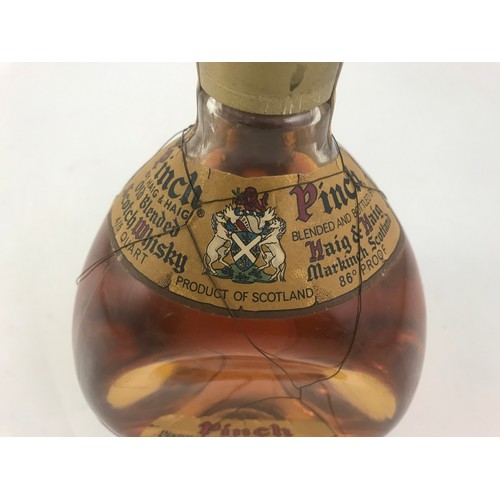 24 - A DIMPLE BOTTLE OF PINCH SCOTCH WHISKEY, BY HAIG & HAIG, 4/5 QUART, UNOPENED