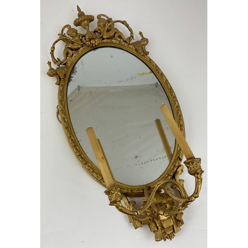 31 - DECORATIVE GILT GIRONDELLE MIRROR WITH TWO CANDLE HOLDERS WITH MERMAID , SWAGS  & URN RELIF DECORATI... 