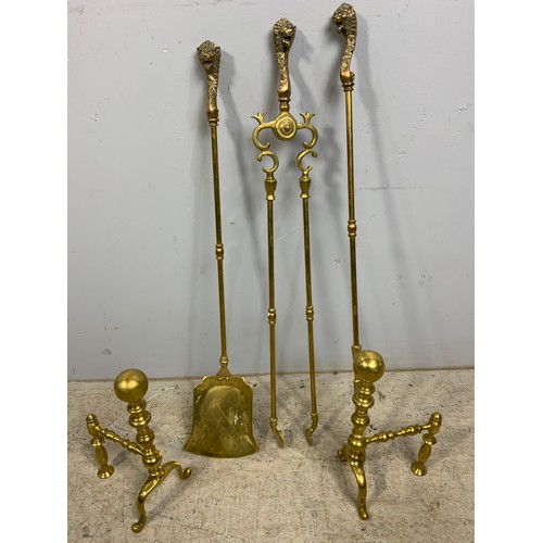 309 - BRASS FIRE IRONS WITH LION HEAD FINIALS AND PR. BRASS FIRE DOGS