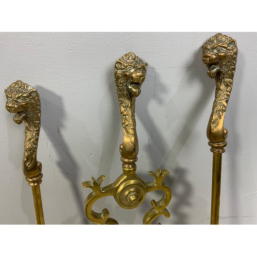 309 - BRASS FIRE IRONS WITH LION HEAD FINIALS AND PR. BRASS FIRE DOGS