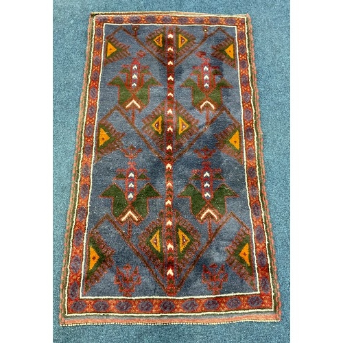 740 - RED AND BLUE GROUND HAND KNOTTED RUG WITH GEOMETRIC DECORATION, APPROX. 156 X 90 cm