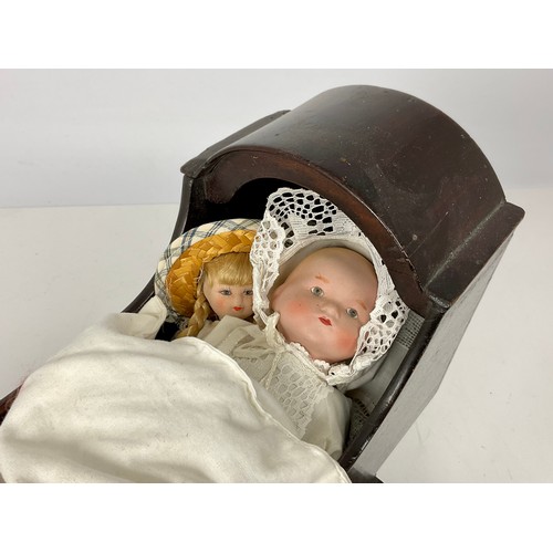 325 - DOLLS PRAM TOGETHER PORCELAIN HEAD DOLL, A ROCKING COT AND 2 OTHER PORCELAIN HEAD DOLLS