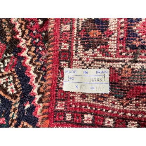 635 - RED GROUND RUG APPROX 153X111 CM