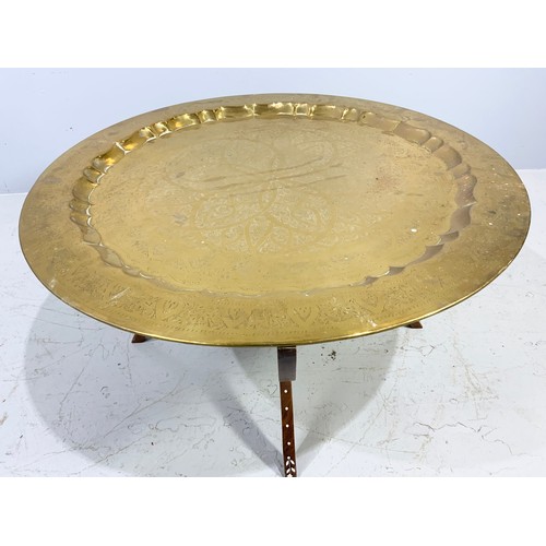 473 - INDIAN BRASS TRAY TABLE ON HARD WOOD STAND 87cm DIAMETER