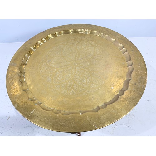 473 - INDIAN BRASS TRAY TABLE ON HARD WOOD STAND 87cm DIAMETER