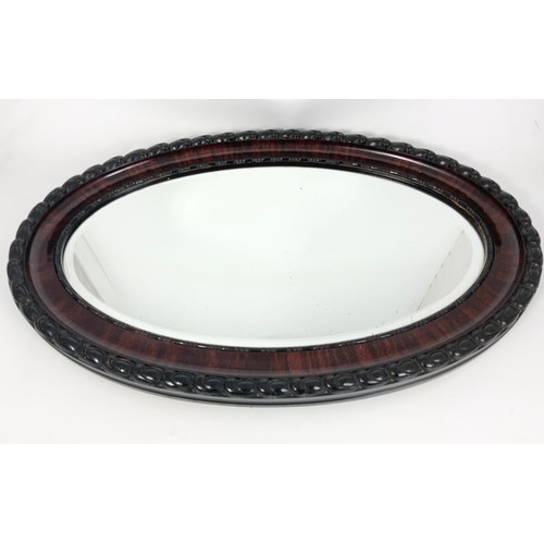 56 - OVAL BEVELLED GLASS MIRROR IN ORNATE FRAME 82cm LONG