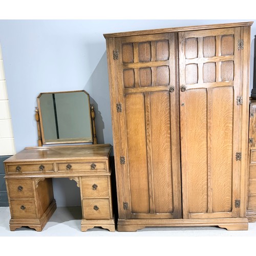 583 - GOOD QUALITY OAK PANELLED BEDROOM SUITE COMPRISING DOUBLE WARDROBE, TALL BOY, BEDSIDE CUPBOARD AND M... 